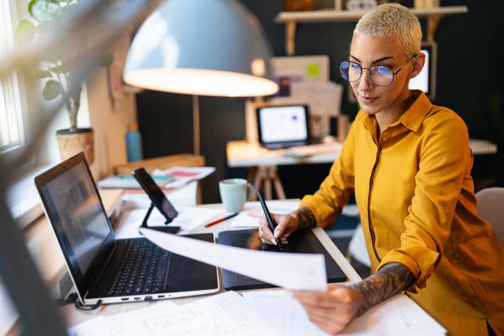 mage showing workspace of a woman who is working on something and showing how graphic design helps business grow as freelance graphic designer
